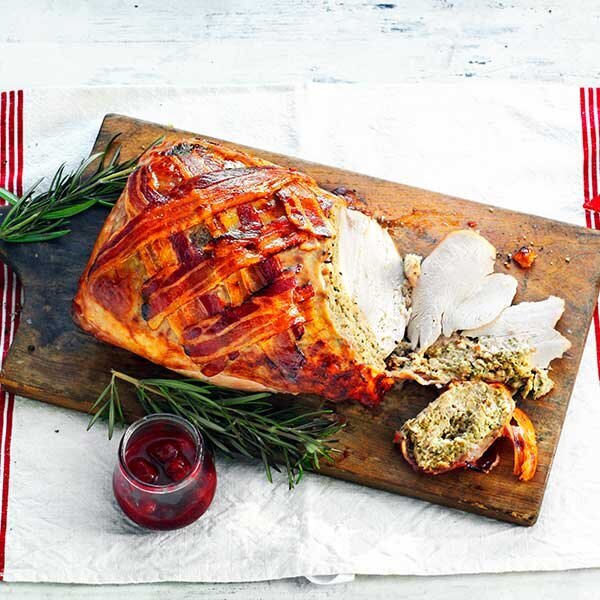 Cooked Turkey Joint Topped With Stuffing And A Bacon Lattice